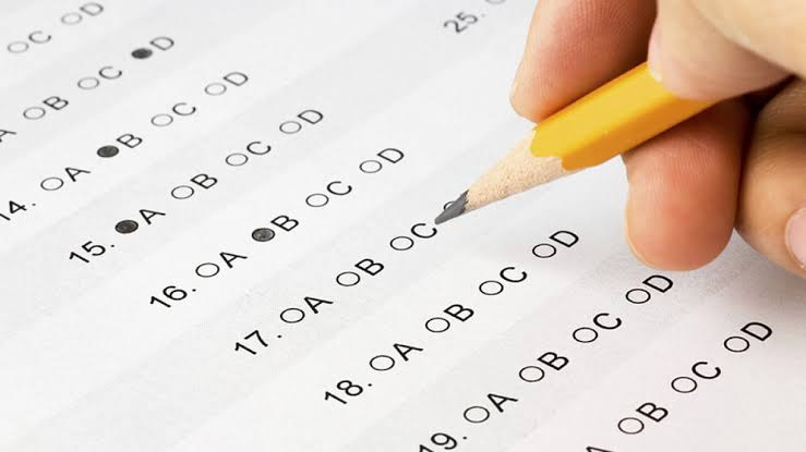 Student completing an exam answer sheet